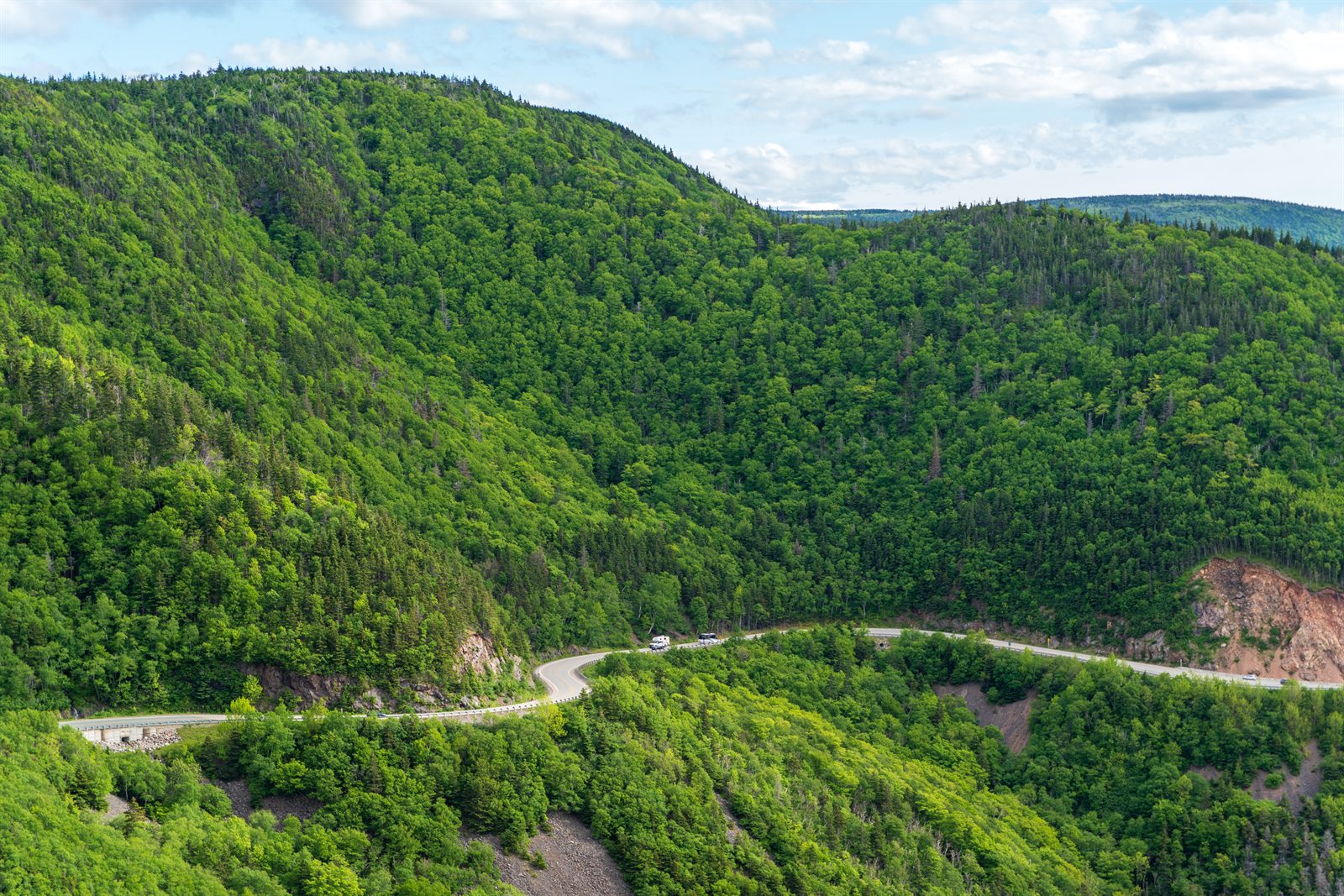 The Cabot Trail winding through forested highlands.