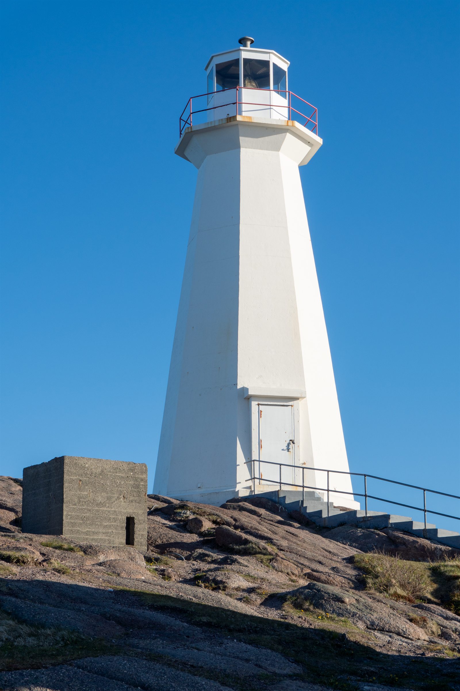 The modern Cape Spear lighthouse against a clear sky.