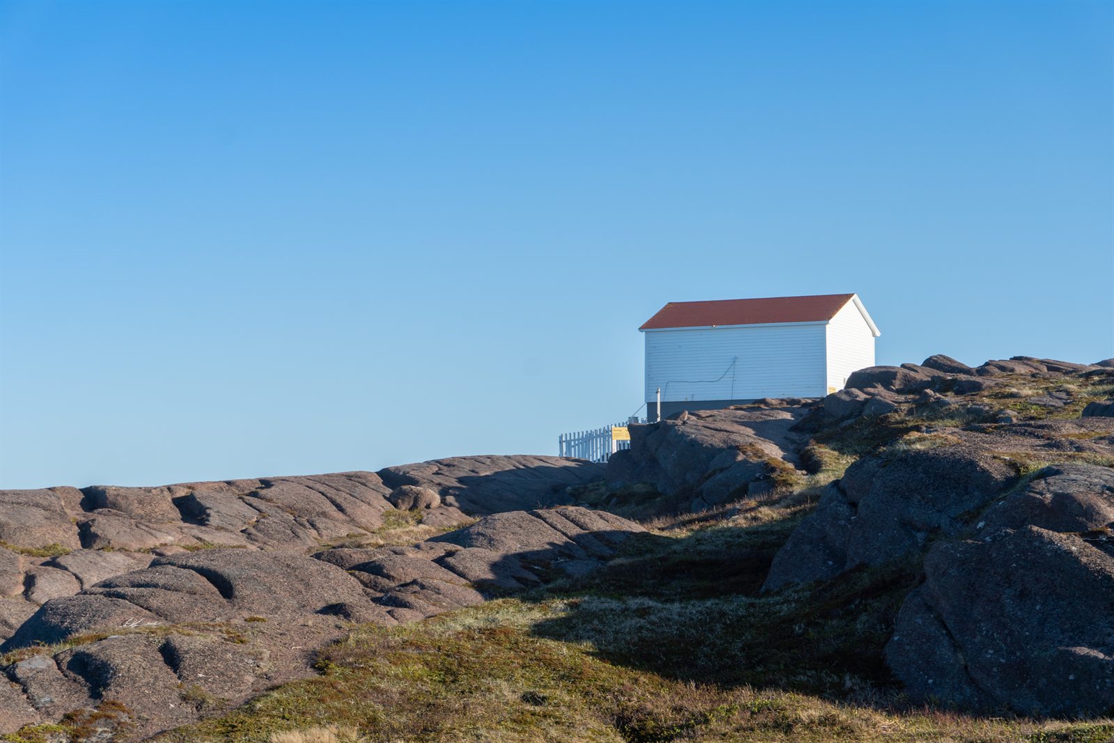 A white shed on the rocky headland at Cape Spear, Newfoundland.
