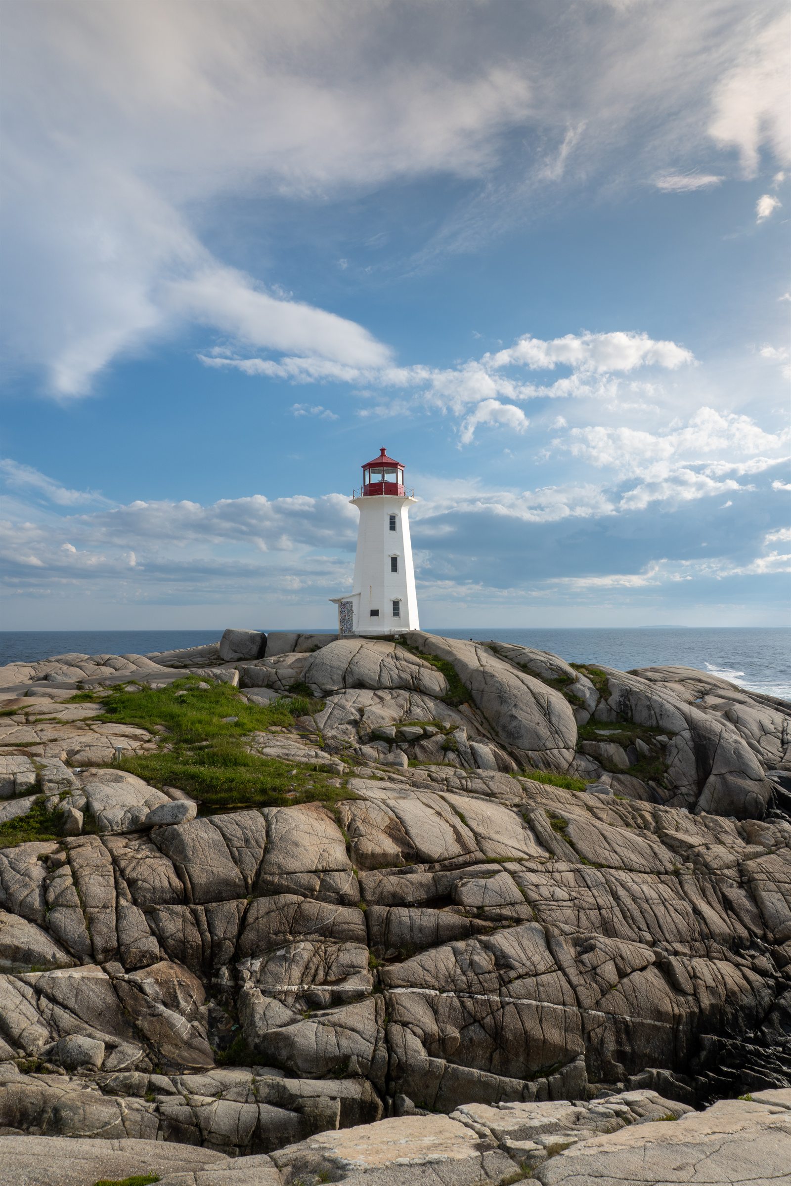 Peggy's Cove lighthouse rising above the granite shoreline.