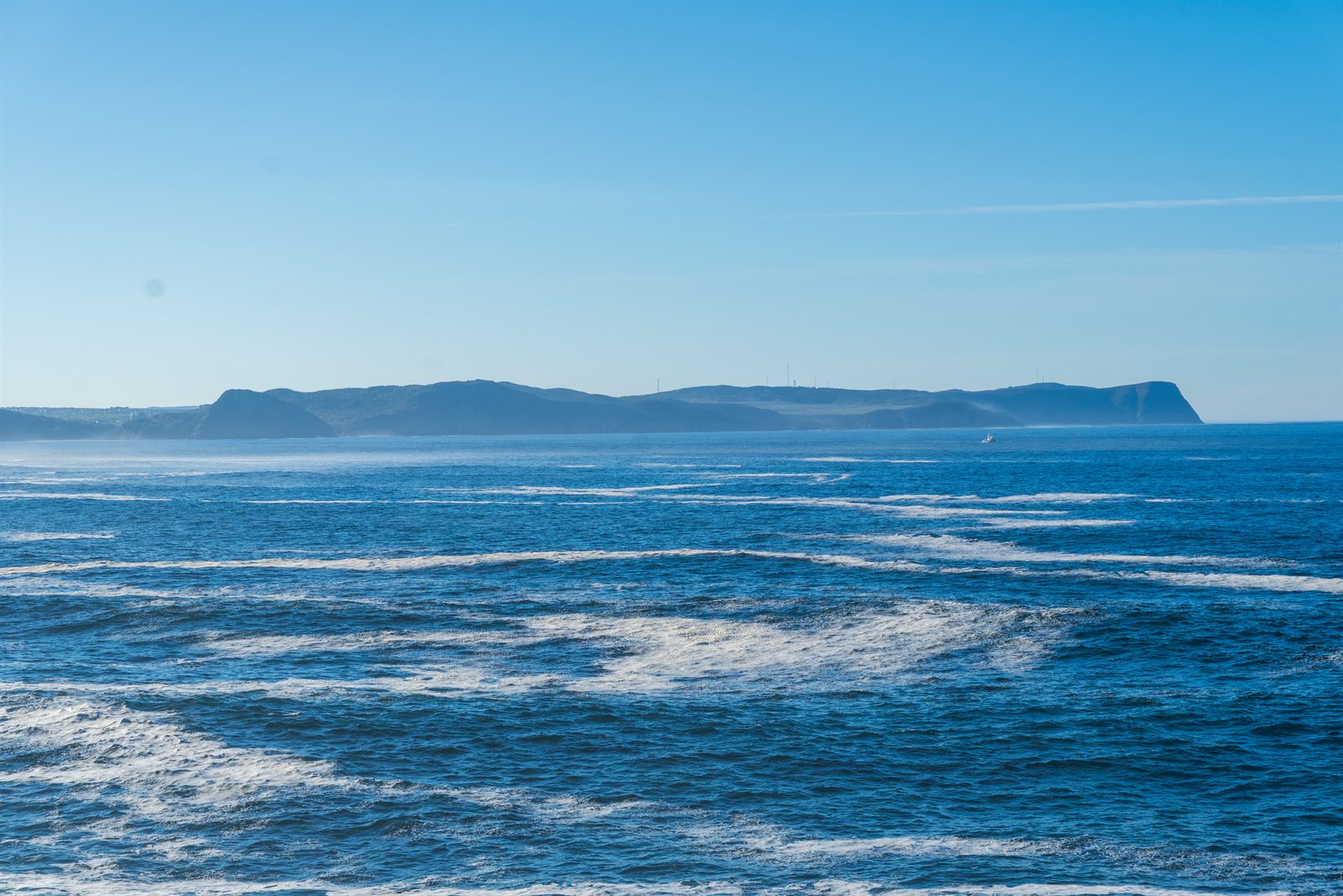 A headland seen across open water from the ferry crossing.