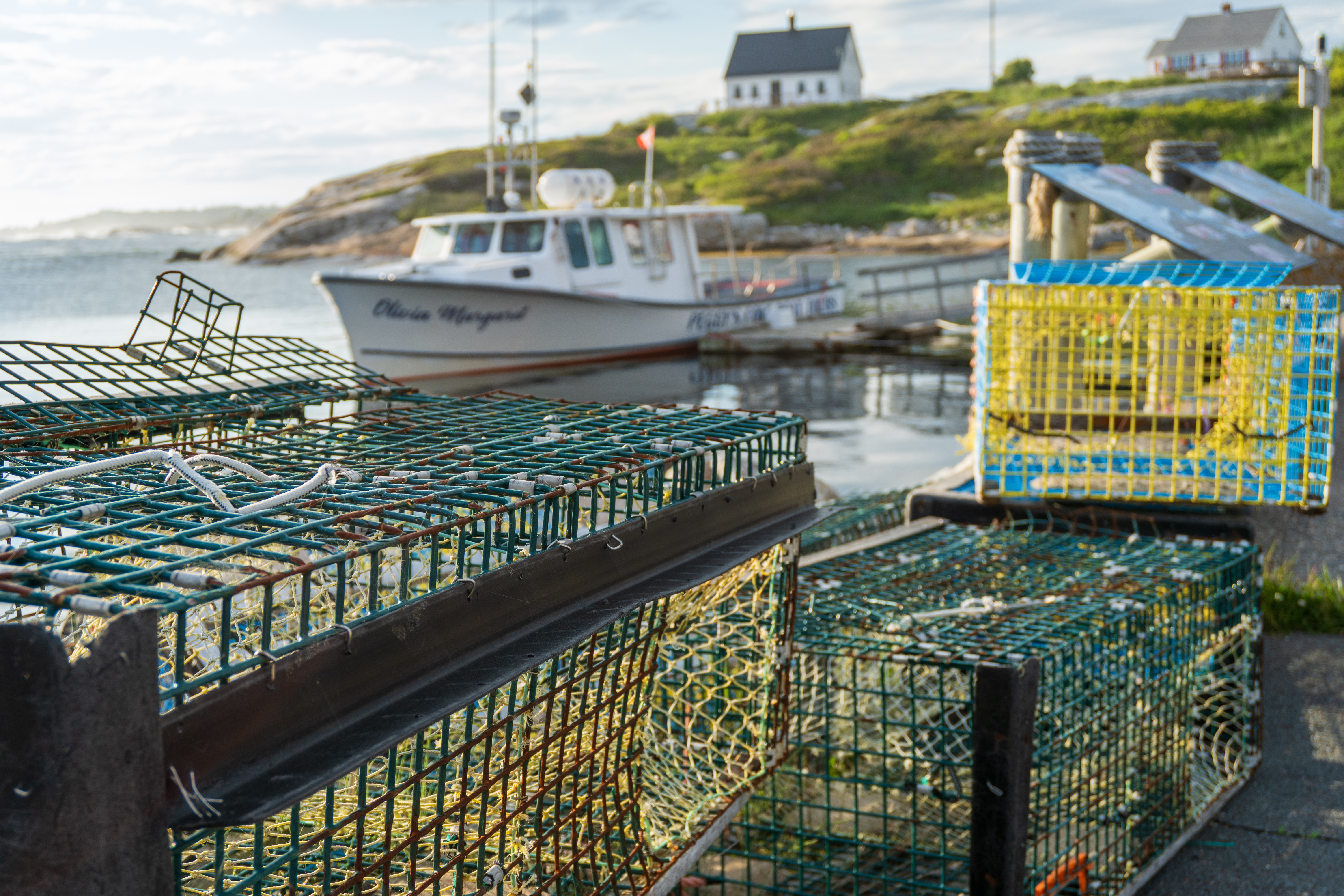 Lobster traps and fishing boats at Peggy's Cove harbour, Nova Scotia