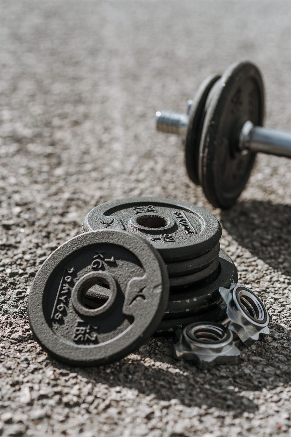 A stack of iron weight plates on the gym floor.